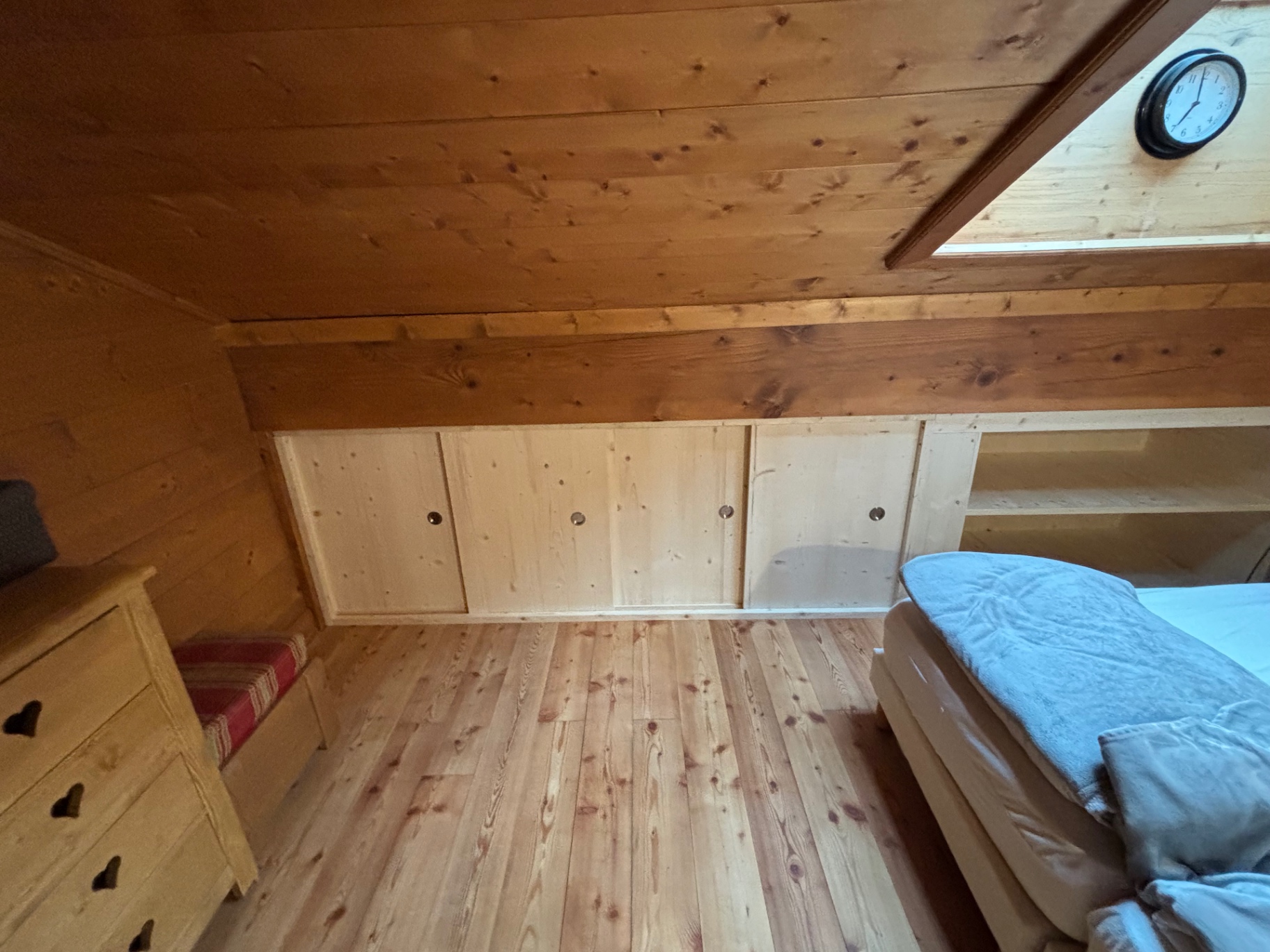 Wood-panelled loft bedroom in a Savoie chalet